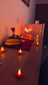 a room with a table with a heart and candles at Sea Garden Peniche in Peniche
