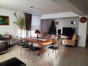 a living room with a table and a christmas tree at Casa Maia in Cîrţişoara