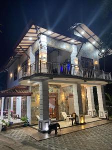 a house with a dog standing in front of it at House of Richness in Negombo