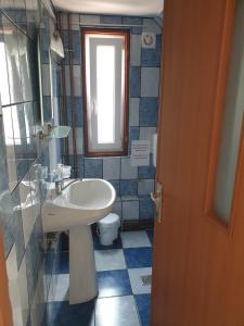 a bathroom with a sink and a toilet at Casa Maia in Cîrţişoara