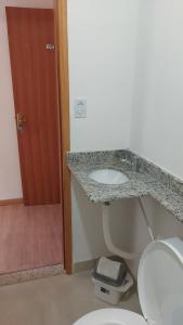 a bathroom with a sink and a toilet at Star Hotel 209 in Juiz de Fora