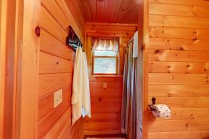 a hallway in a log cabin with a window at Lenas in Waterville