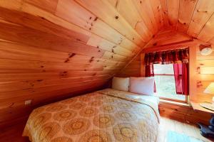 a bedroom with a bed in a wooden cabin at Lenas' Lakeside Cabin in Waterville