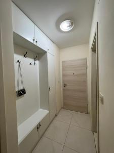 a bathroom with a walk in closet and a door at Oscar in Podgorica