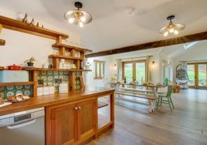 a kitchen with wooden cabinets and a dining room at Tyn y Maes in Bethesda