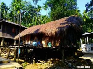 a hut with a thatched roof on top of it at Jaldapara Binaychapa homestay in Mādāri Hāt