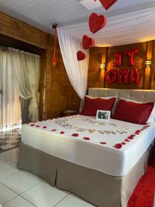 a bedroom with a large bed with hearts on the wall at Cabana Amor Perfeito in Alfredo Wagner