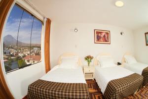 Postel nebo postele na pokoji v ubytování Astorga Hotel Arequipa