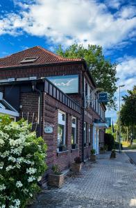 a brick building on a cobblestone street at Hotel Restaurant Verst in Gronau