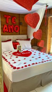 a bedroom with a bed with red hearts on it at Cabana Amor Perfeito in Alfredo Wagner