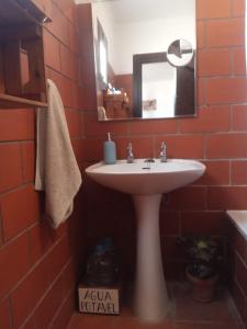 a bathroom with a white sink and a mirror at Monte da Samarra - Alojamento Local in Avis