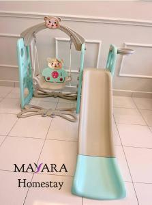 a toy swing with a hello kitty in it at MAYARA Homestay @ Residensi Lili in Nilai
