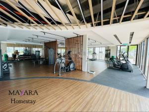 a gym with treadmills and exercise bikes in a room at MAYARA Homestay @ Residensi Lili in Nilai