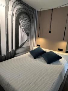 a bed with two pillows on it in a tunnel at Alfea Suite in Bologna