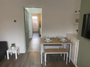 a dining room with a table and chairs and a hallway at Montrose - Perfect contractor stay, own driveway, 3 bedrooms in Gateshead
