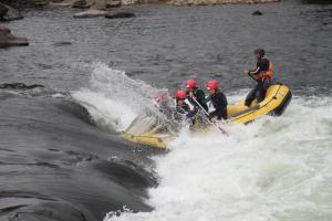 a group of people on a raft in the water at La Favorita in Pontevedra