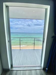 a view of the ocean from a room with a window at Villas Encanto in Baru