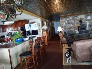 a kitchen and living room with a counter and a stove at 2,000 ft home on the St Lawrence, incredible views Canada, hot tub in Ogdensburg