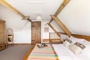 a bedroom with a large white bed and wooden beams at Self-Catering at Craft Renaissance in Usk