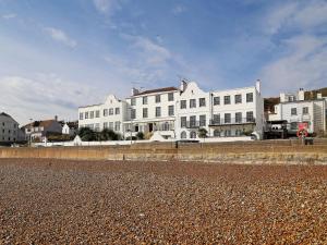 a group of white buildings on the beach at Seashore Apartment in Sandgate