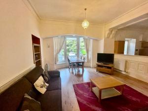 a living room with a couch and a table at Serviced Accommodation Moray - Lesmurdie House No 2 in Elgin