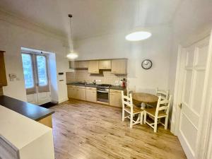 a kitchen with a table and chairs in a room at Serviced Accommodation Moray - Lesmurdie House No 2 in Elgin