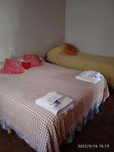 a room with two beds with towels on them at Villa Lidia in Mar del Plata