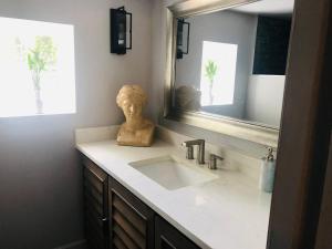 a bathroom with a sink and a mirror at Savannah Sojourn - Time Travelers Retreat 1853 in Savannah