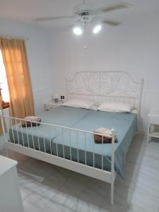 a bedroom with a bed with a blue comforter at Blue Island House on the hill in Los Cristianos