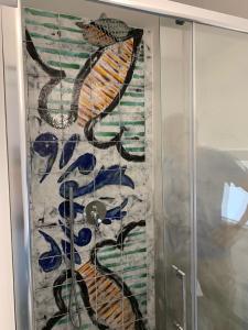 a painting of a fish on a glass door at Le Case di Don Andrea in Minori