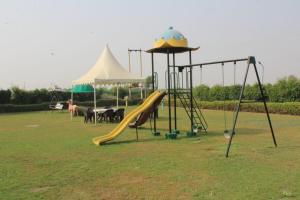 a playground with a slide and a tent at Elegance Resort in Jait
