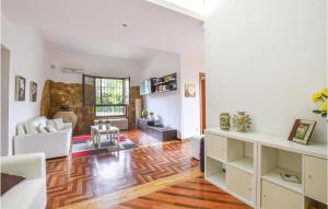 a living room with white walls and a wooden floor at 4 Bedroom Lovely Home In Caltagirone in Caltagirone