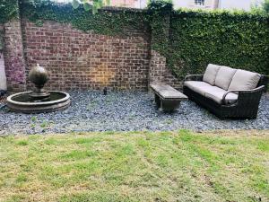 a couch and a coffee table in a yard at Savannah Sojourn - Time Travelers Retreat 1853 in Savannah