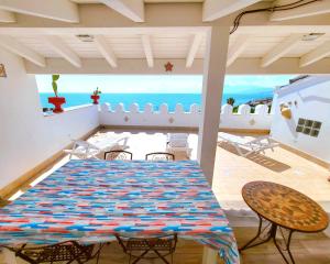 a dining room with a table and chairs and the ocean at Seafront House Gabbiano Azzurro in Santa Flavia