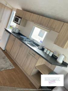 an overhead view of a kitchen with wooden cabinets at Robin hood Caravan park North Wales Free Wi-Fi and Smart TVs Passes not included in Rhyl
