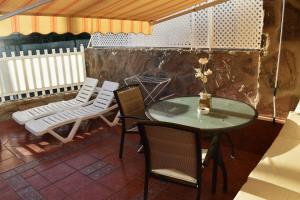a table and chairs sitting on a patio at Bungalow Guayana in Mogán