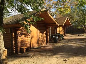 a log cabin with a door in front of it at The Lazy Lizard Hostel in Moab