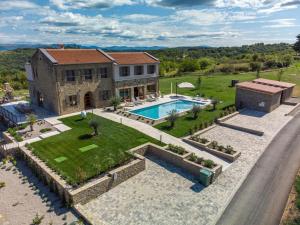 an aerial view of a house with a swimming pool at Villa Paradiso dIstria with Spa and heated pool in Kućibreg
