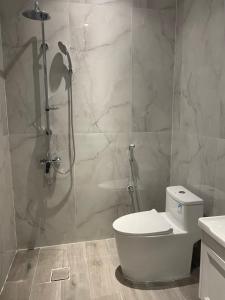 a bathroom with a shower and a toilet in it at Anan Suites in Dammam