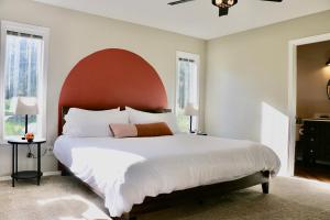 a bedroom with a large bed with a red headboard at Glenwood Pines in Flagstaff