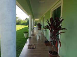 a porch of a house with a table and a plant at Recanto Elohim in Itapira