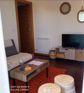 a living room with a couch and a coffee table at El Pisito de Baiona in Baiona