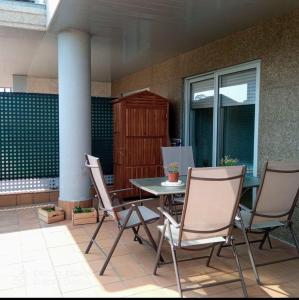 a table and chairs sitting on a patio at El Pisito de Baiona in Baiona