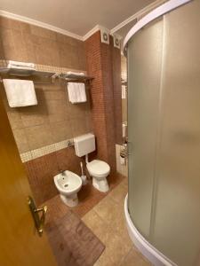 a bathroom with a toilet and a glass shower at Apartment Blue Eko Fis Vlašić in Vlasic