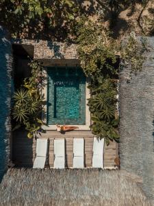 a group of chairs sitting in front of a pool at Villa Alegria - La Villa Group in Jericoacoara