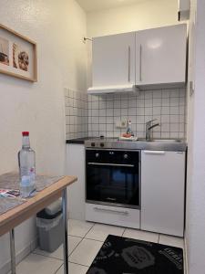 a kitchen with a sink and a stove at Ferienwohnung Mainz Bahnhof in Mainz