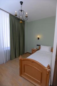 Ein Bett oder Betten in einem Zimmer der Unterkunft Old Avenue Hotel