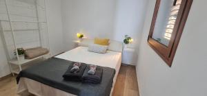 a small bedroom with a bed with shoes on it at Lina House Garden, BBQ & Outdoor Dining in Puntagorda
