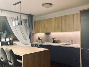 a kitchen with blue cabinets and a wooden table at Ferienwohnung Berghausen in Berghausen