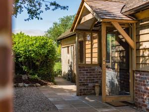 an extension to a house with a wooden door at Norwood Dairy in Bredgar